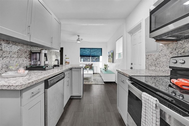 kitchen featuring tasteful backsplash, stainless steel appliances, ceiling fan, white cabinets, and dark hardwood / wood-style floors