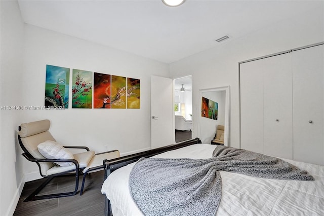 bedroom with hardwood / wood-style floors and a closet