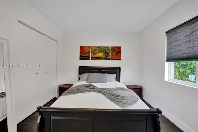 bedroom with dark hardwood / wood-style flooring