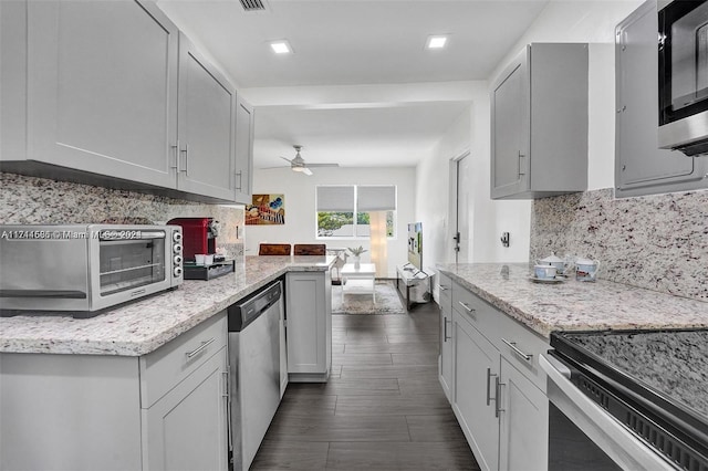 kitchen with stainless steel dishwasher, ceiling fan, light stone counters, and decorative backsplash