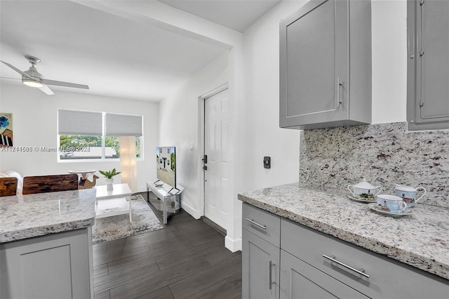 kitchen featuring gray cabinets, ceiling fan, and dark hardwood / wood-style floors