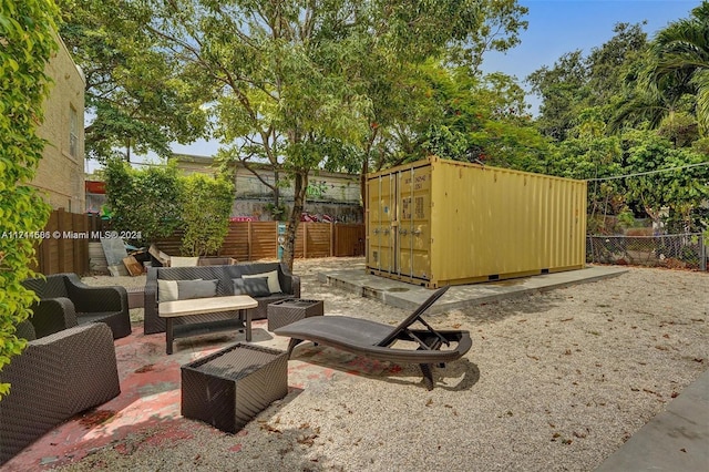 view of patio featuring outdoor lounge area and a shed