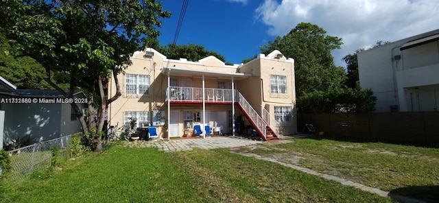 rear view of house featuring a lawn