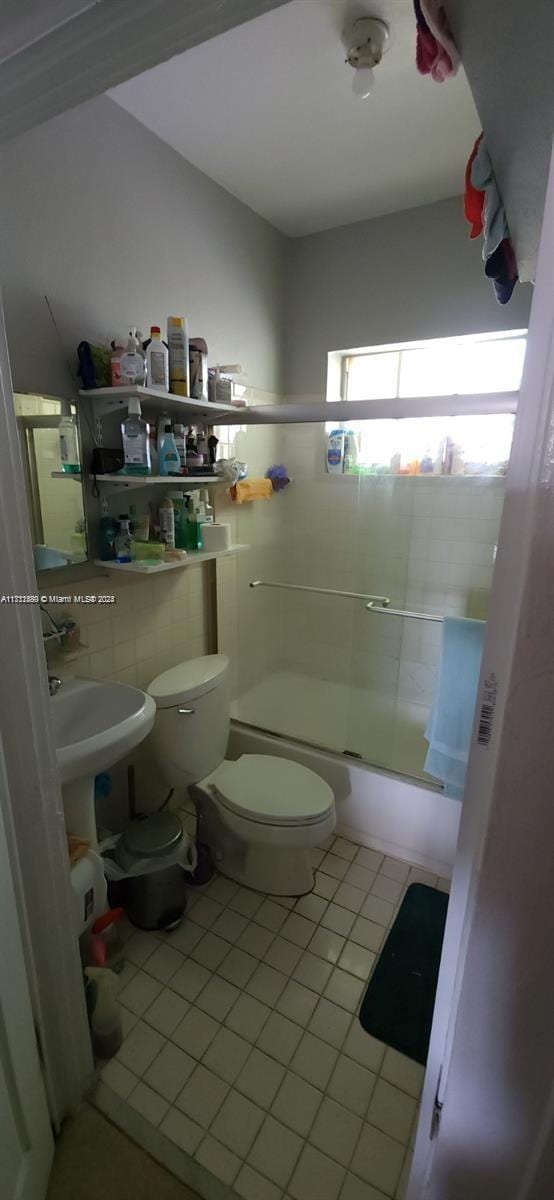 251 NW 34th Ter, Miami, FL 33127 - full bathroom featuring tile patterned floors and shower / bath combination with glass door