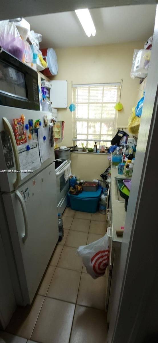 251 NW 34th Ter, Miami, FL 33127 - laundry area featuring light tile patterned flooring