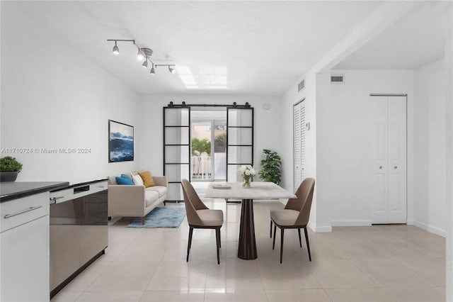 dining space featuring light tile patterned floors