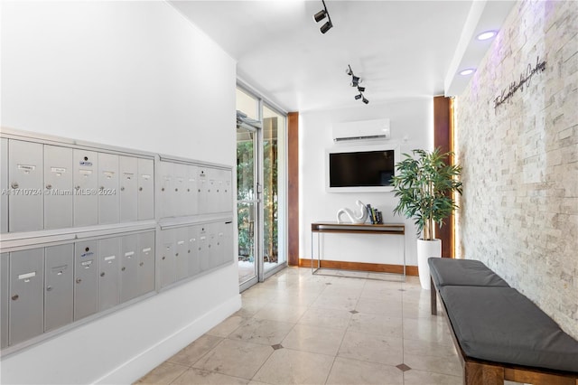 hallway with a mail area and an AC wall unit