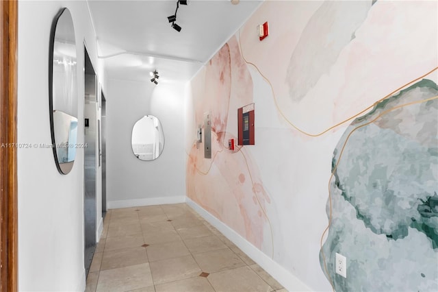 hallway with electric panel and light tile patterned floors