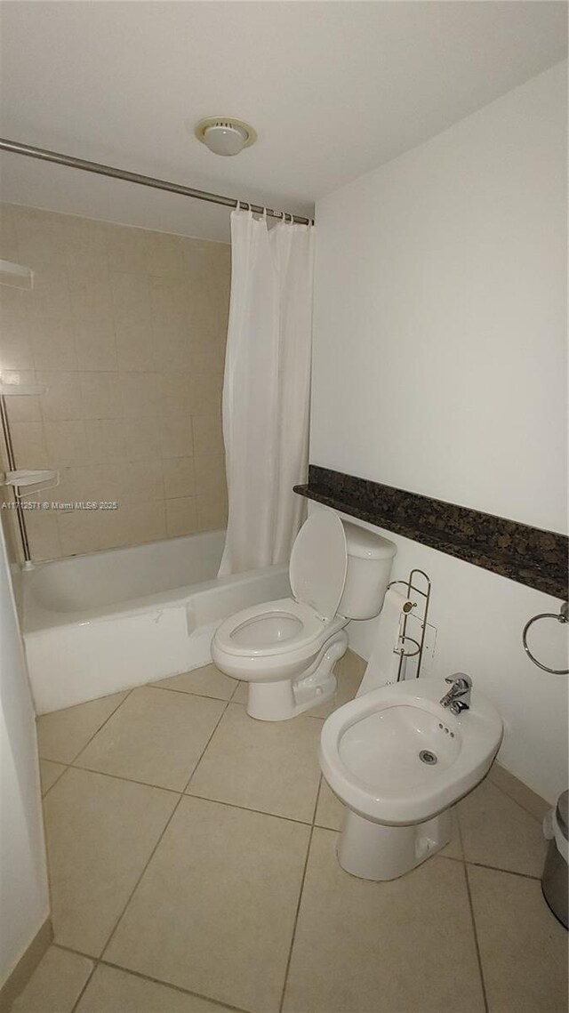 bathroom with tile patterned floors, a bidet, toilet, and shower / tub combo