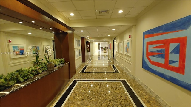 corridor featuring a paneled ceiling