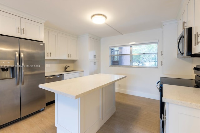 kitchen featuring white cabinetry, sink, and appliances with stainless steel finishes