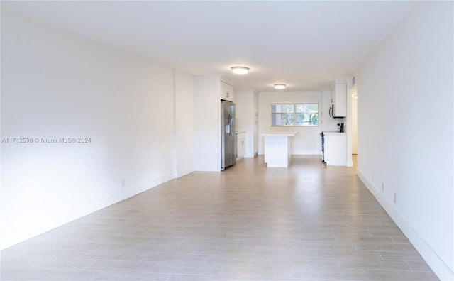 spare room featuring light hardwood / wood-style flooring