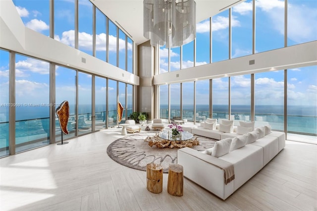 sunroom with plenty of natural light and a water view