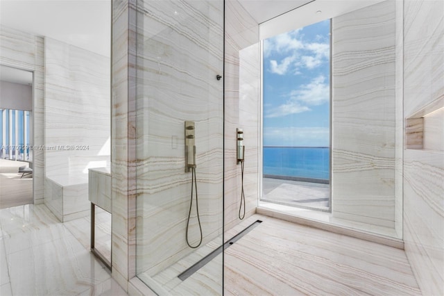 bathroom with a healthy amount of sunlight and a water view