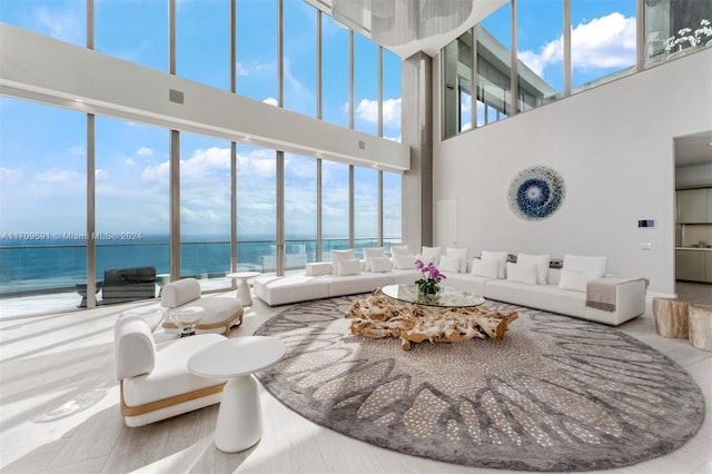 living room with a wealth of natural light, a water view, and hardwood / wood-style flooring