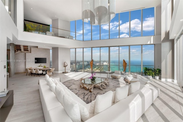 living room with light hardwood / wood-style floors and a high ceiling