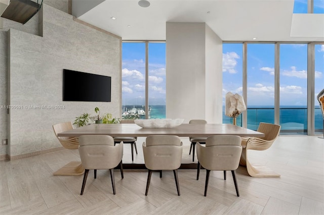 dining space featuring floor to ceiling windows and light hardwood / wood-style floors