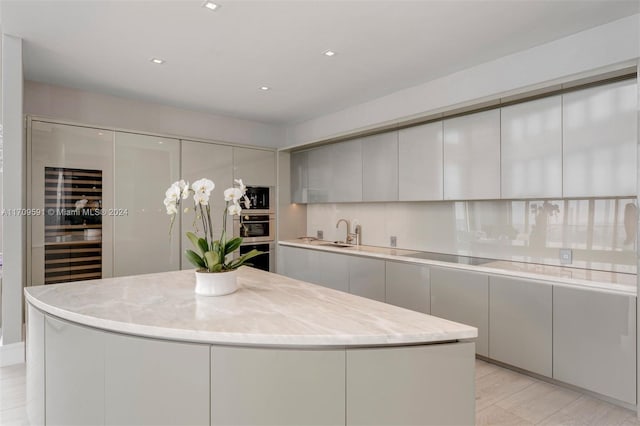 kitchen with decorative backsplash, a center island, black electric cooktop, and built in microwave