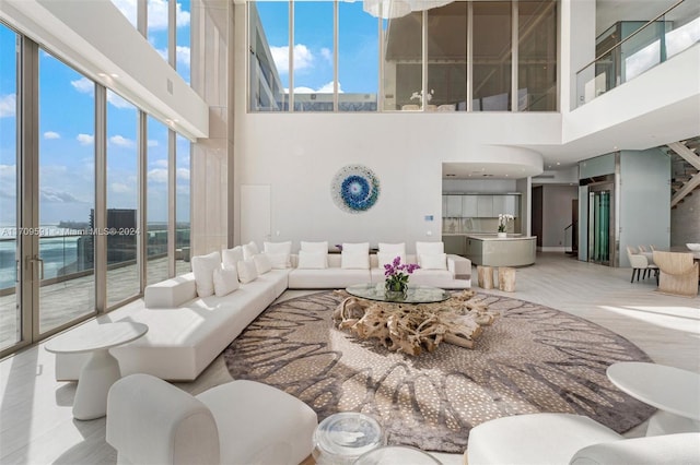 living room with plenty of natural light and a high ceiling