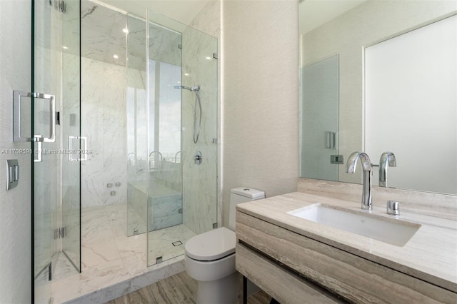 bathroom featuring wood-type flooring, vanity, toilet, and an enclosed shower