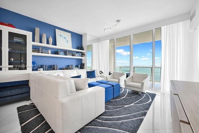 living room with light tile patterned flooring and a water view