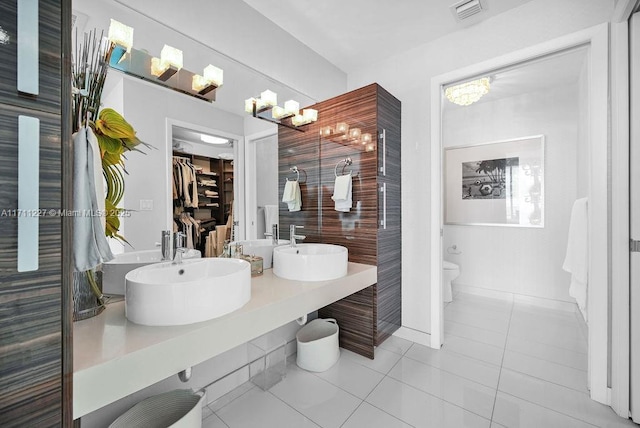 bathroom featuring tile patterned floors, vanity, and toilet