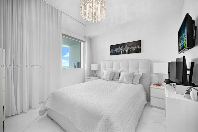 bedroom featuring a notable chandelier and light tile patterned floors