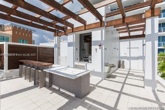 view of patio / terrace featuring a pergola and an outdoor bar