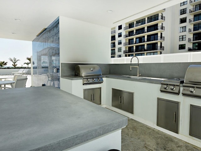 view of patio / terrace with a grill, exterior kitchen, and sink