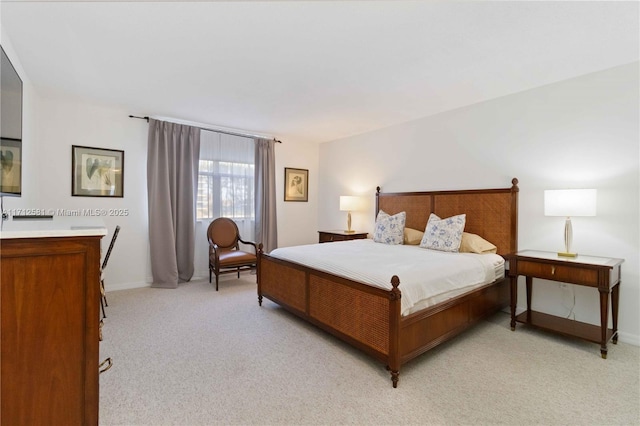 bedroom featuring light carpet and baseboards