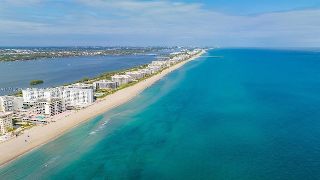 drone / aerial view with a beach view and a water view