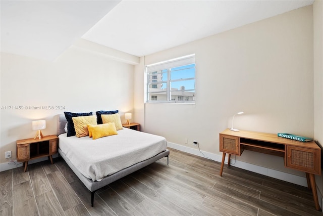 bedroom with wood-type flooring