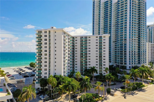 view of property with a water view and a view of the beach