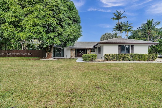 ranch-style home with a front lawn