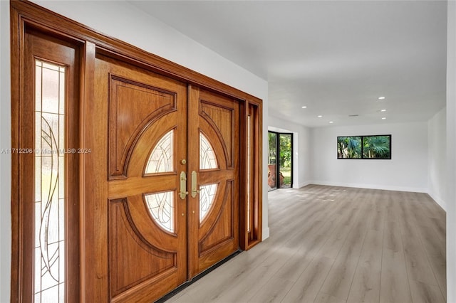 foyer entrance featuring french doors and light hardwood / wood-style flooring