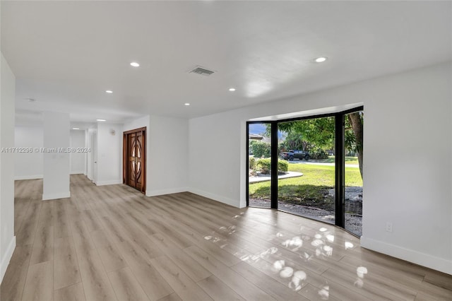 unfurnished room with light hardwood / wood-style floors