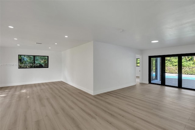 spare room featuring light hardwood / wood-style floors