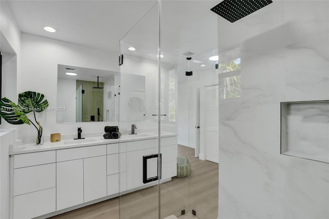 bathroom featuring hardwood / wood-style floors, vanity, and an enclosed shower