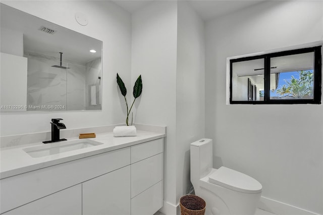 bathroom featuring vanity, toilet, and a shower with shower door