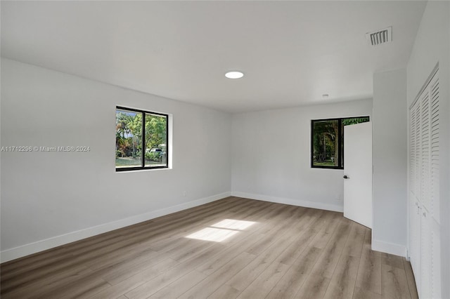 unfurnished bedroom featuring a closet and light hardwood / wood-style flooring