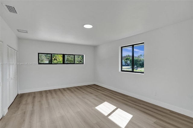 unfurnished bedroom featuring a closet and light hardwood / wood-style floors