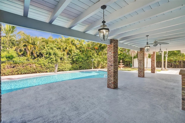 view of swimming pool featuring ceiling fan and a patio