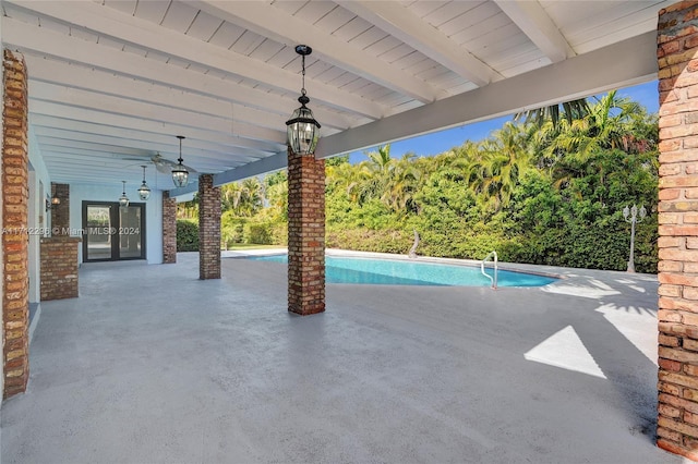 view of pool featuring ceiling fan, a patio, and french doors