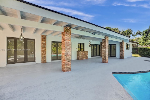 view of pool featuring ceiling fan, a patio area, and french doors