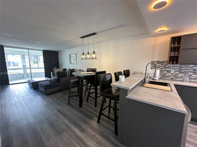 kitchen featuring a kitchen breakfast bar, sink, and dark hardwood / wood-style floors