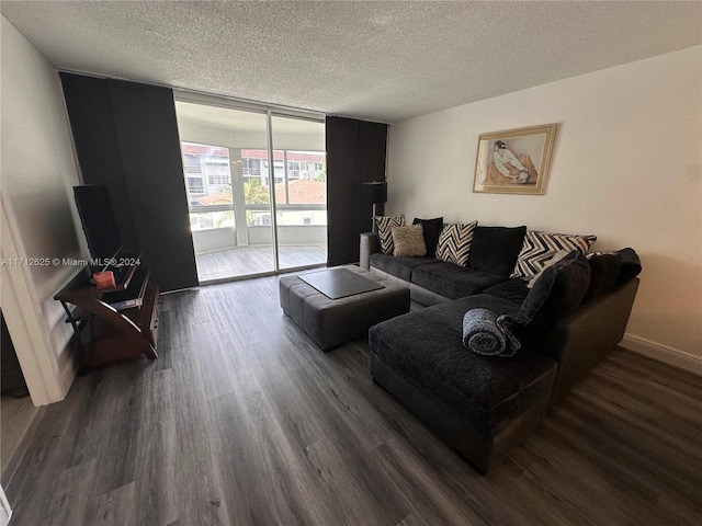 living room featuring a textured ceiling, dark hardwood / wood-style floors, and a wall of windows