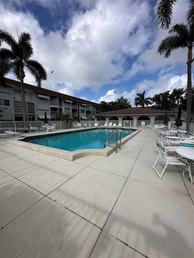 view of swimming pool with a patio area