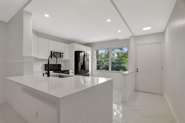 kitchen featuring white cabinetry, electric range, light stone countertops, black refrigerator with ice dispenser, and kitchen peninsula