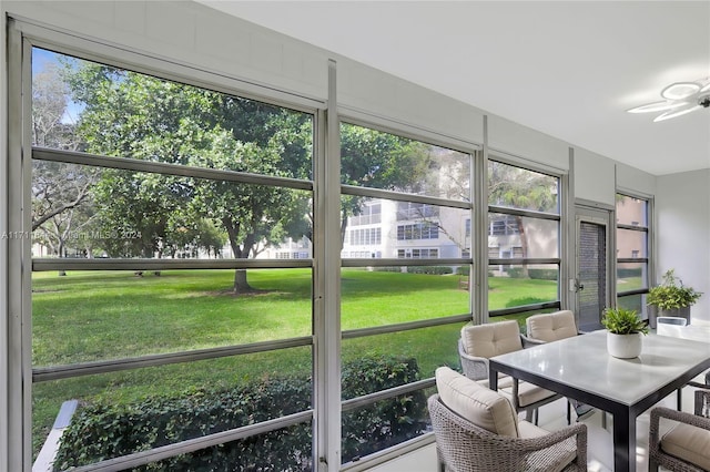 sunroom with a wealth of natural light and ceiling fan