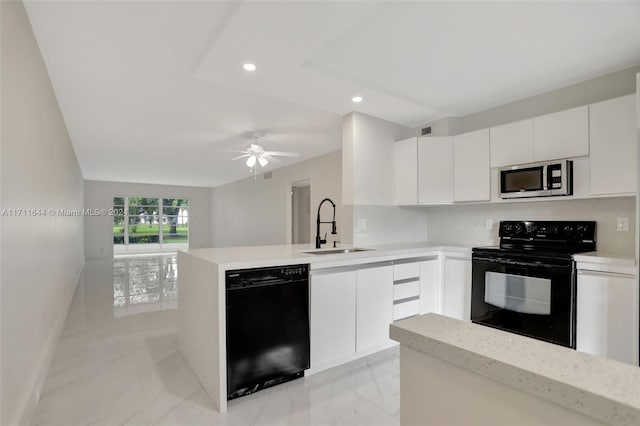 kitchen with black appliances, white cabinets, kitchen peninsula, and tasteful backsplash